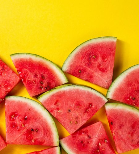 Beautiful pattern with fresh watermelon slices on yellow bright background. Top View. Copy Space.